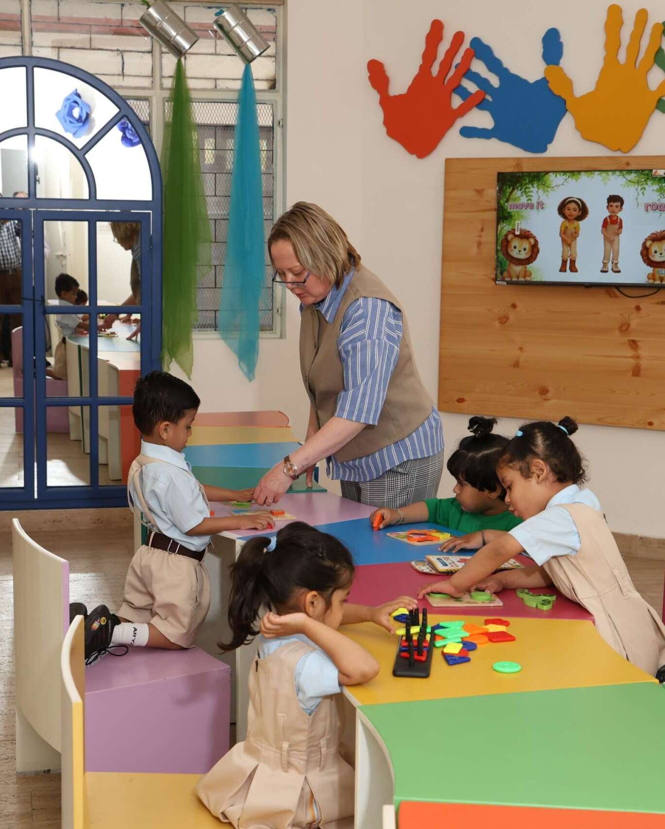 Playgroup teachers with children in safe Dehradun preschool