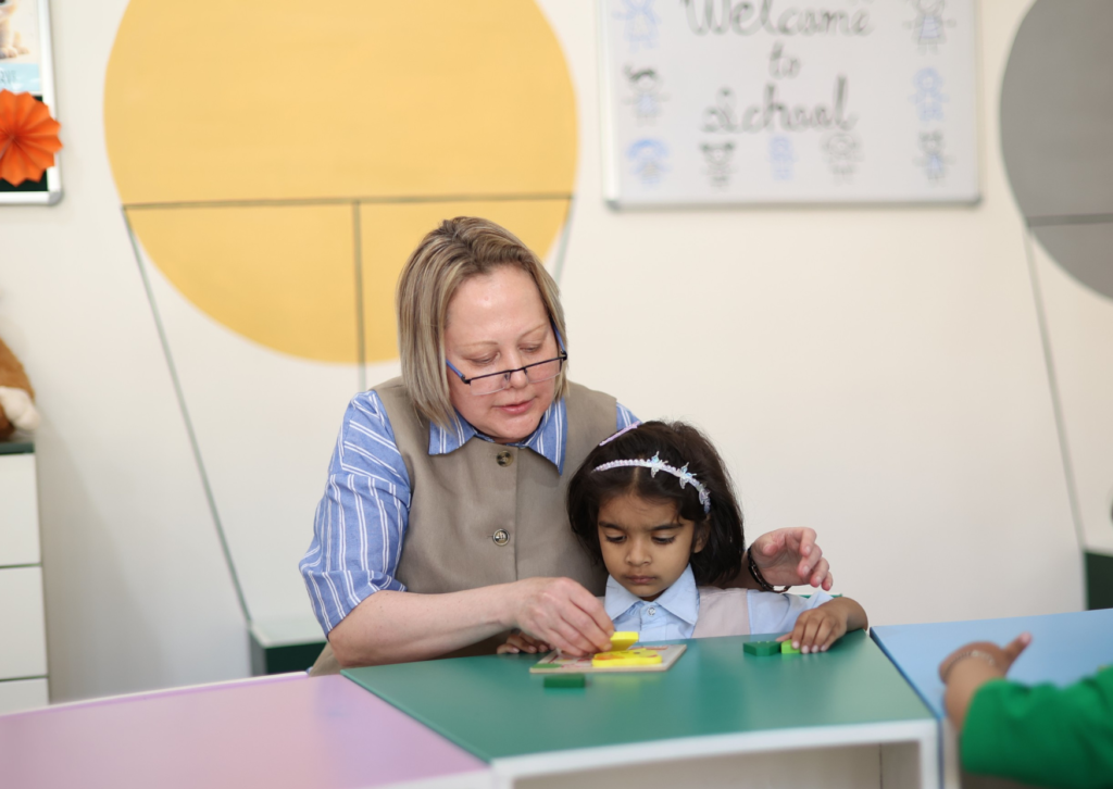 Playgroup teachers with children in safe Dehradun preschool